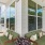 a balcony with green couches and windows