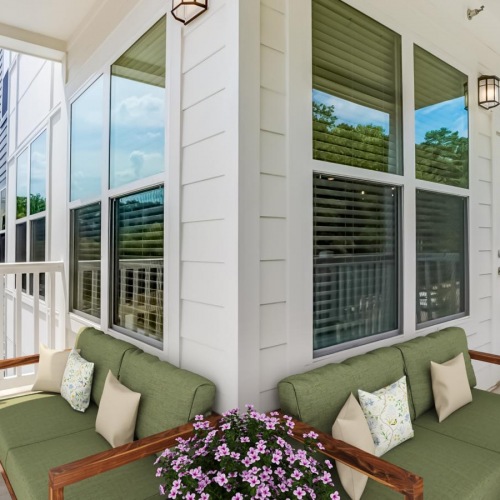 Generous balconies a balcony with green couches and windows