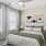 a bedroom with a bed and a fan